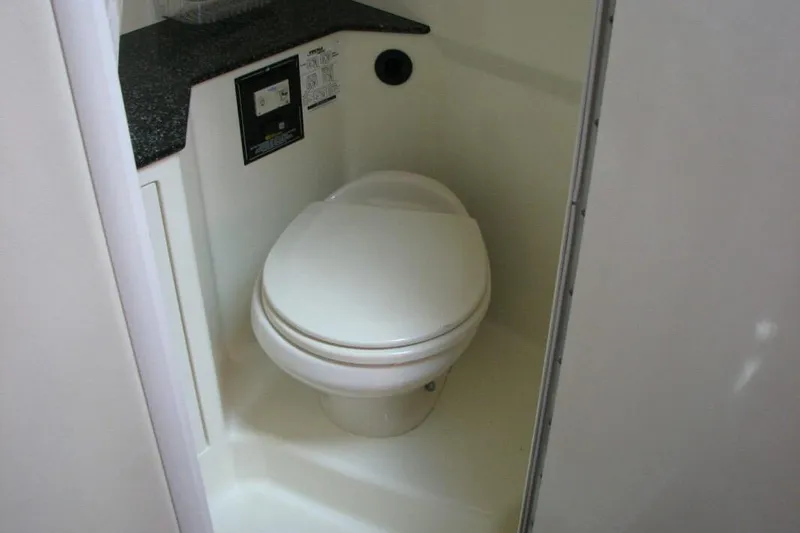 Slide: The Image of Compact bathroom with toilet in 2014 Monterey 280 Sport Yacht. - 8