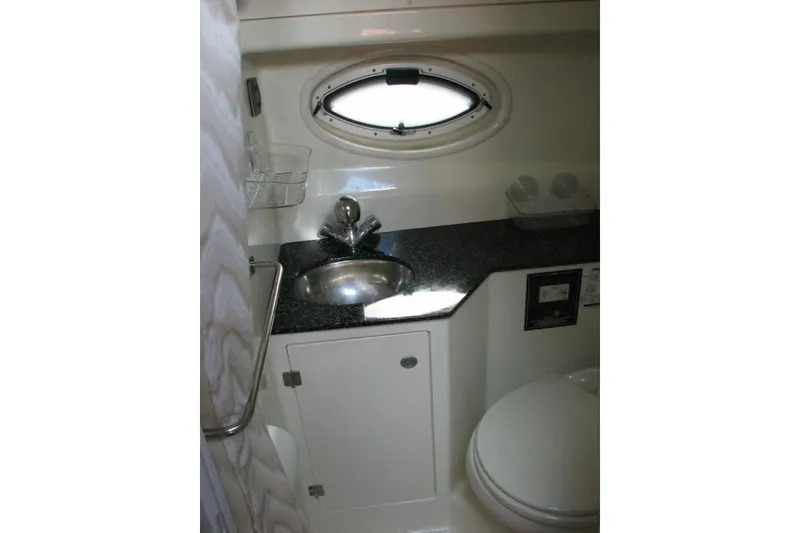 Slide: The Image of Bathroom interior of 2014 Monterey 280 Sport Yacht with sink, toilet, and porthole window. - 9
