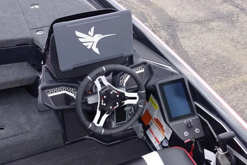 Slide: The Image of 2026 Skeeter FXR20 PRO boat cockpit with steering wheel and digital display. - 11