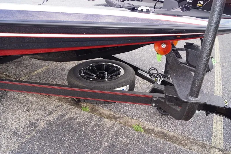 Slide: The Image of 2026 Skeeter FXR20 PRO boat trailer with spare tire on pavement. - 4