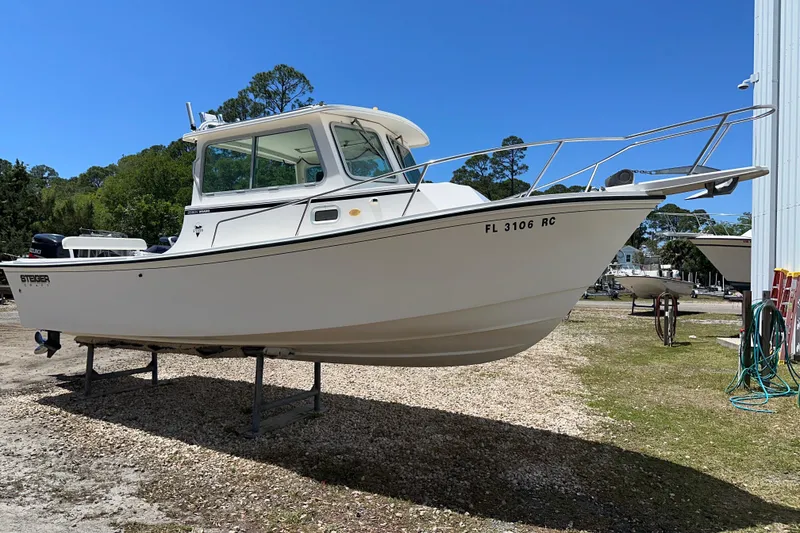 The Image of 2009 Steiger Craft 255 Miami boat on display outdoors, clear sky background. - 0