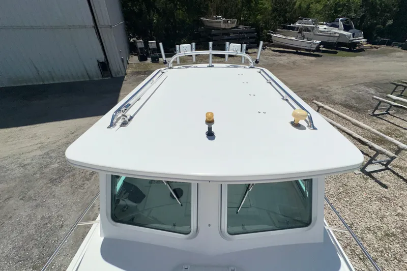 Slide: The Image of 2009 Steiger Craft 255 Miami boat roof view at a marina. - 15