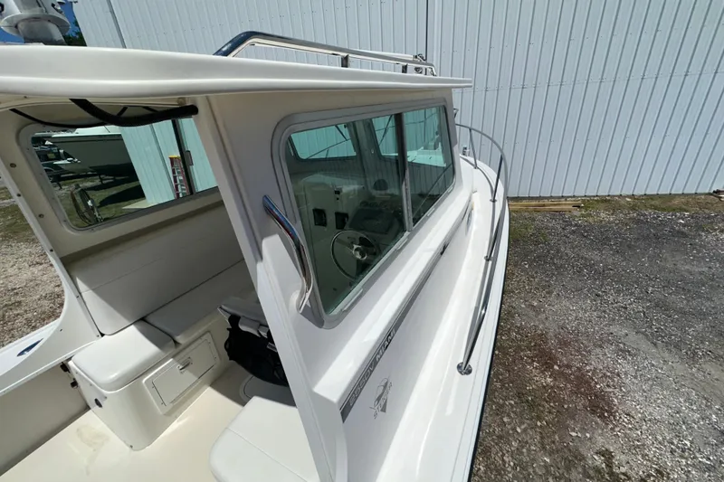 Slide: The Image of 2009 Steiger Craft 255 Miami boat, side view with cabin and railing details. - 17