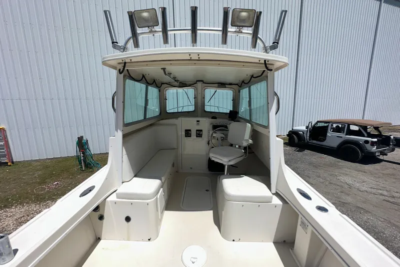 Slide: The Image of 2009 Steiger Craft 255 Miami boat interior with seating and steering console. - 19