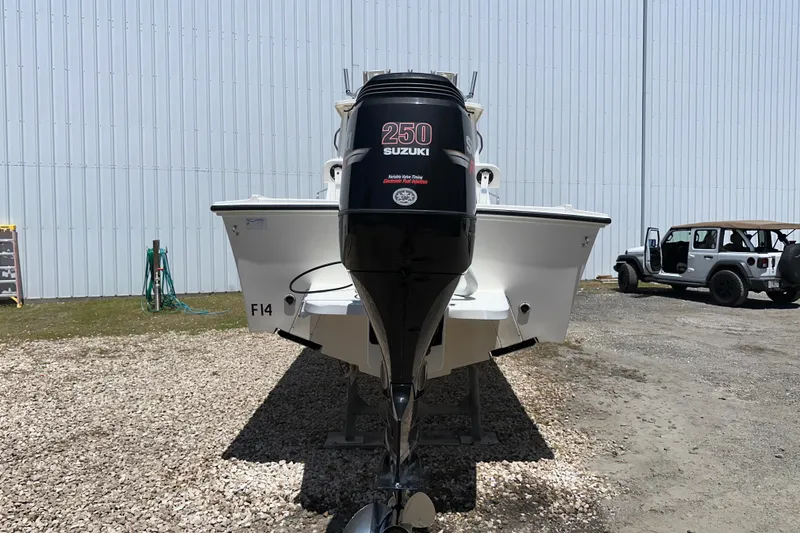 Slide: The Image of 2009 Steiger Craft 255 Miami boat with Suzuki 250 engine, parked outdoors. - 2