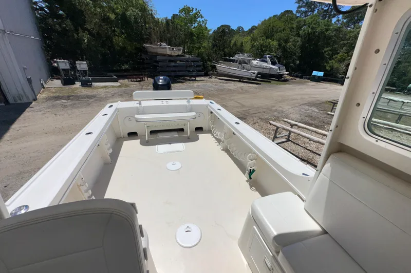 Slide: The Image of 2009 Steiger Craft 255 Miami boat deck with seating, parked outdoors. - 24