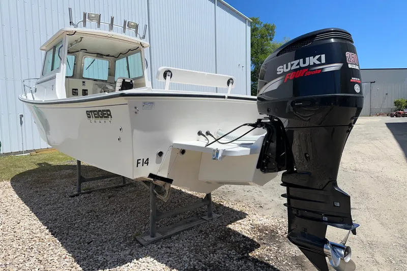 Slide: The Image of 2009 Steiger Craft 255 Miami boat with Suzuki 250 Four Stroke engine, parked outdoors. - 3