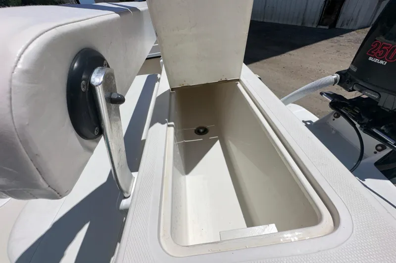 Slide: The Image of Open storage compartment on a 2009 Steiger Craft 255 Miami boat, featuring a Suzuki 250 engine. - 34