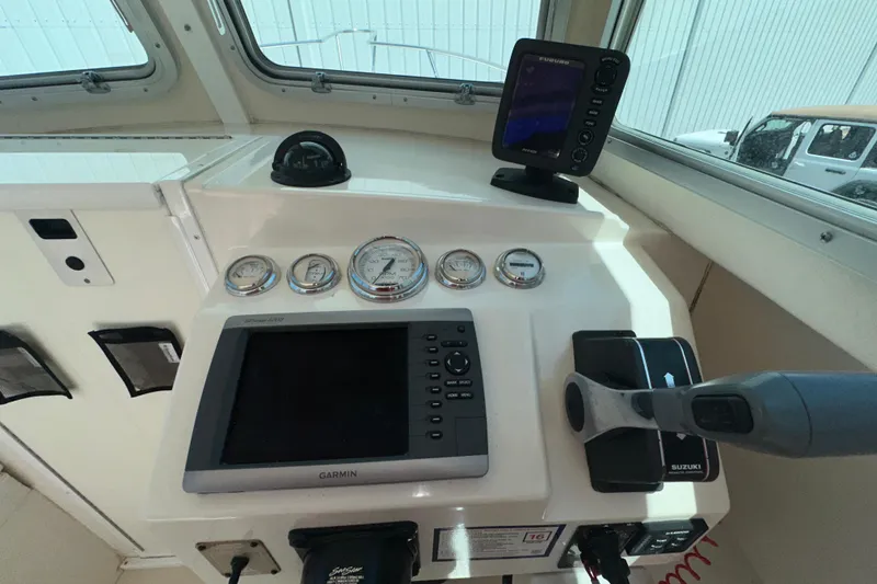 Slide: The Image of 2009 Steiger Craft 255 Miami boat dashboard with Garmin and Furuno navigation systems. - 39