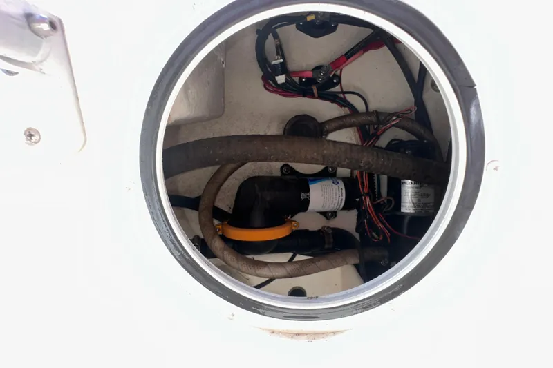 Slide: The Image of 2009 Steiger Craft 255 Miami boat compartment with wiring and hoses visible. - 41