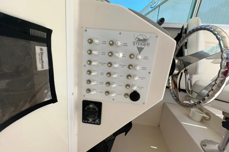 Slide: The Image of Control panel of a 2009 Steiger Craft 255 Miami boat with steering wheel. - 48