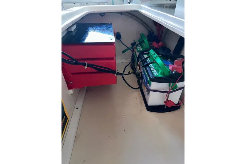 Slide: The Image of 2009 Steiger Craft 255 Miami boat battery compartment with wiring and storage. - 50