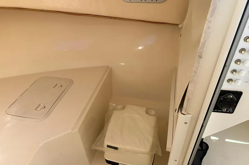 Slide: The Image of 2009 Steiger Craft 255 Miami cabin interior with storage compartment and covered toilet. - 52
