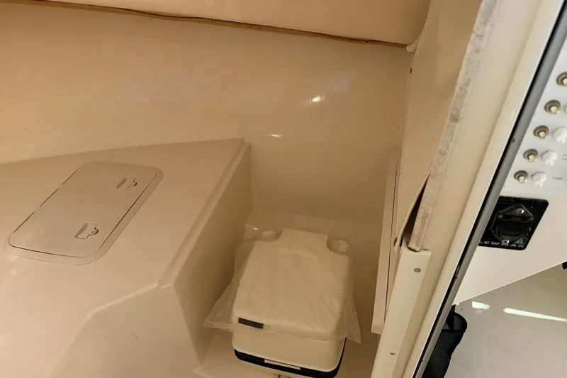 Slide: The Image of Interior of 2009 Steiger Craft 255 Miami boat, featuring storage compartment and control panel. - 53