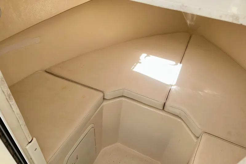 Slide: The Image of 2009 Steiger Craft 255 Miami cabin interior with beige cushions and storage space. - 54