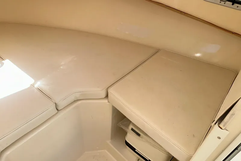 Slide: The Image of Interior cabin of 2009 Steiger Craft 255 Miami boat with cushioned seating. - 58