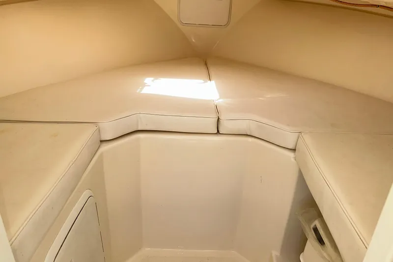 Slide: The Image of 2009 Steiger Craft 255 Miami cabin interior with cushioned seating and storage. - 59