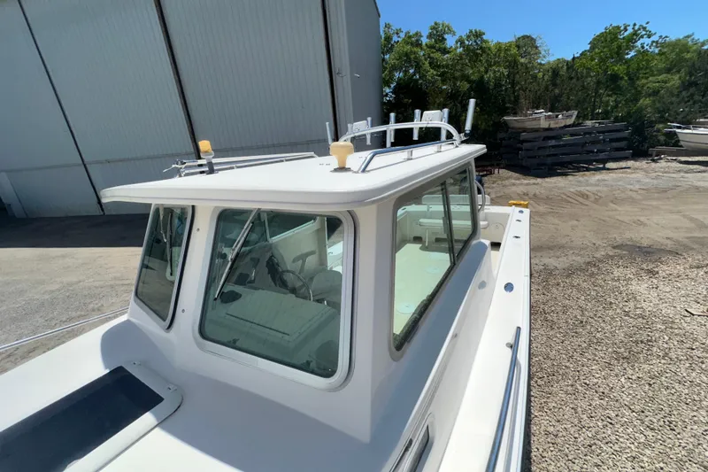 Slide: The Image of 2009 Steiger Craft 255 Miami boat docked near a warehouse. - 8