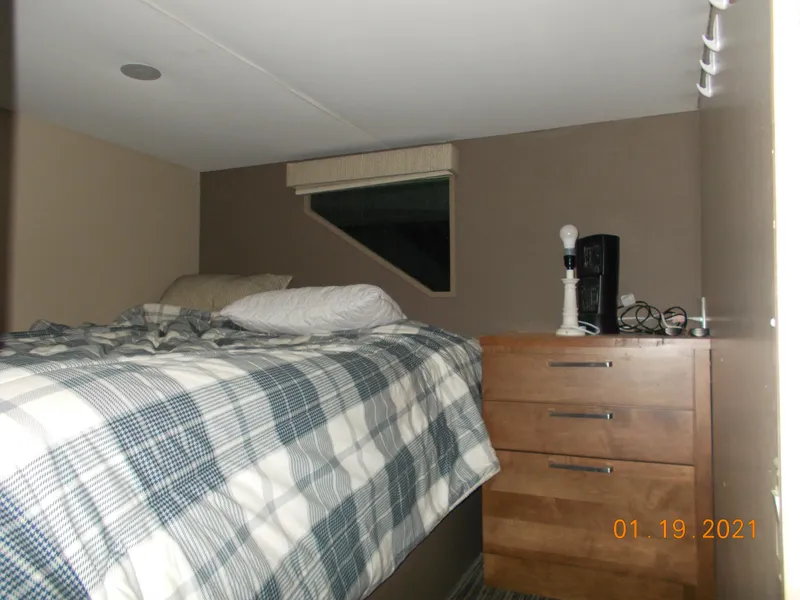 Slide: The Image of Cozy bedroom in a 2015 Bravada Discovery Trip RV. - 13