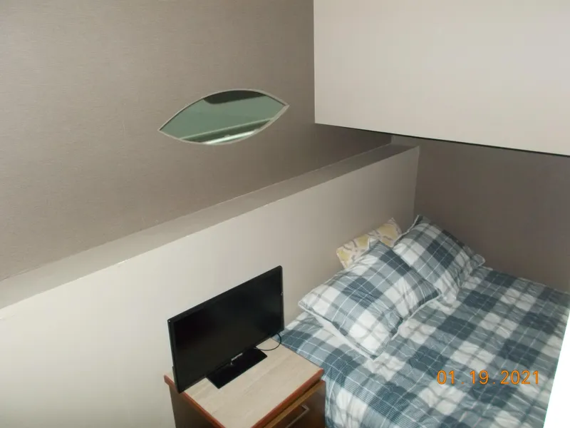 Slide: The Image of Compact bedroom with bed, TV, and modern design. - 17