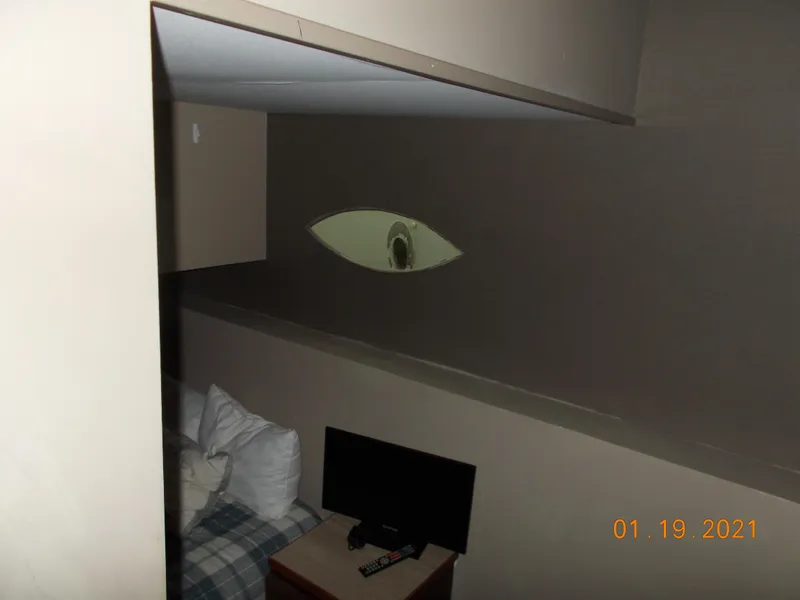 Slide: The Image of Cozy room with TV, pillows, and unique wall decor. - 18