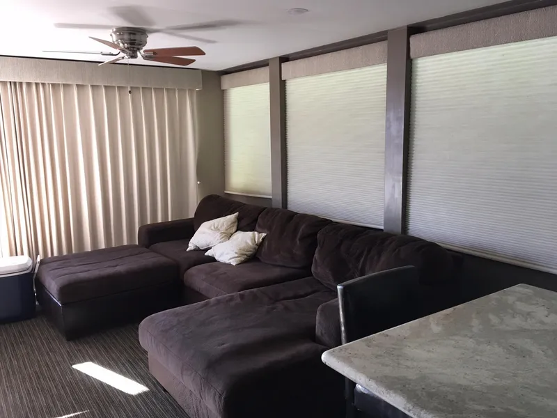 Slide: The Image of Cozy living room with brown sofa and ceiling fan. - 2