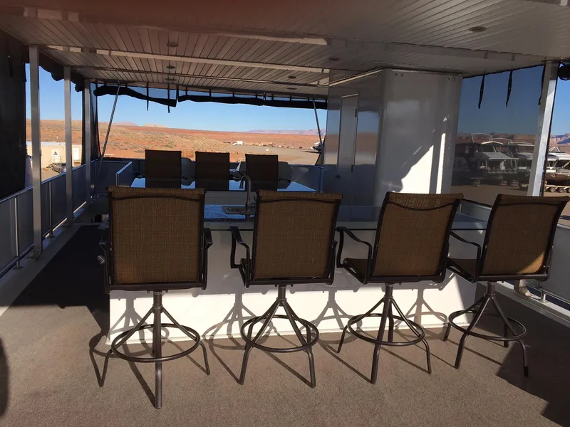 Slide: The Image of Upper deck of a Bravada houseboat with bar stools and table. - 7