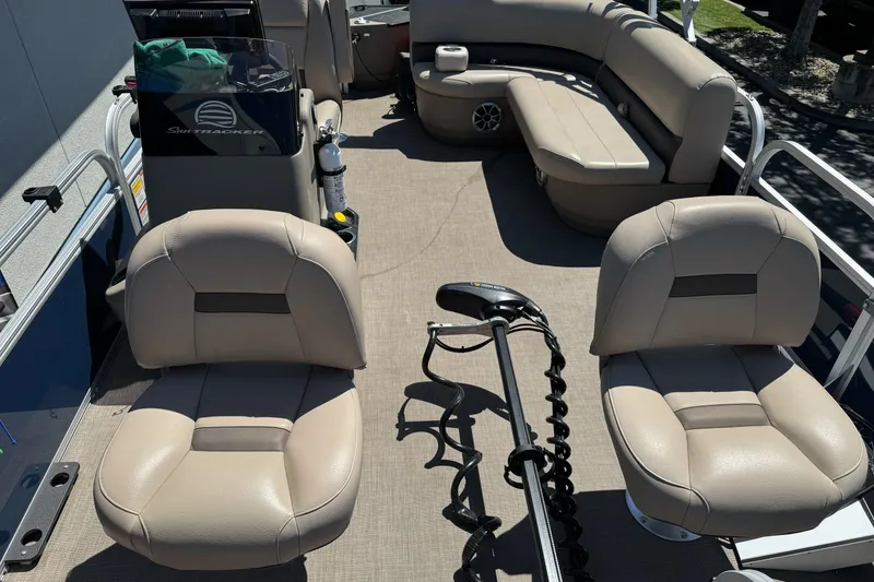 Slide: The Image of 2025 Sun Tracker Bass Buggy 18 DLX pontoon boat interior with seating and steering console. - 13