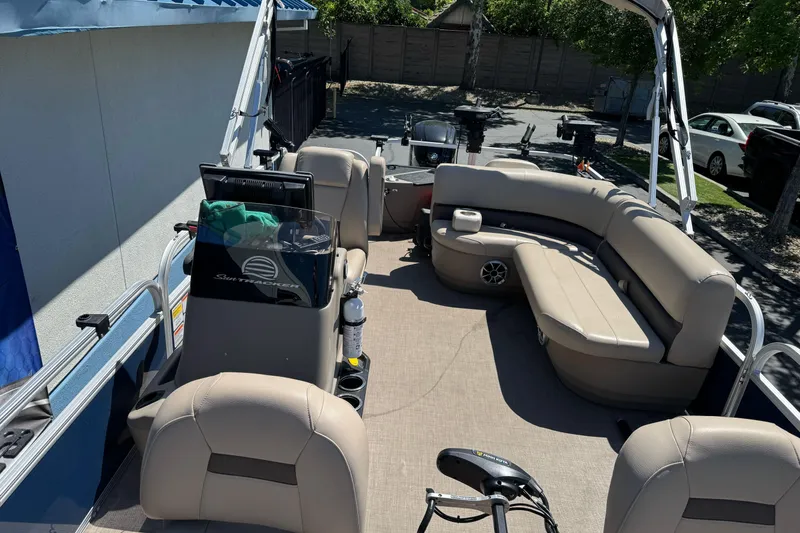 Slide: The Image of Interior of 2025 Sun Tracker Bass Buggy 18 DLX pontoon boat with beige seating. - 14