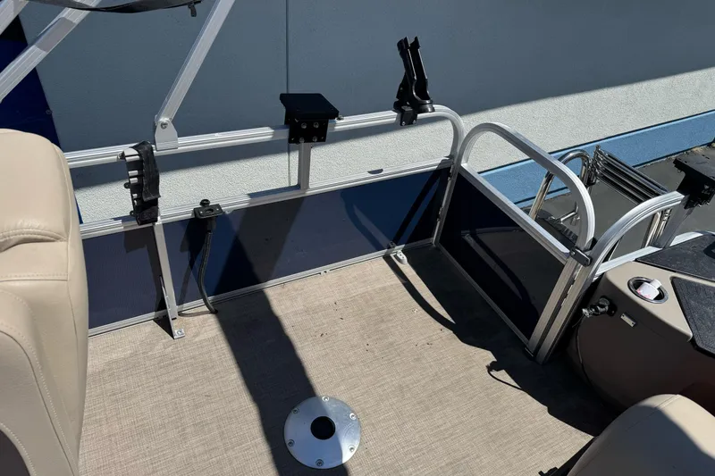 Slide: The Image of 2025 Sun Tracker Bass Buggy 18 DLX interior with seating and fishing rod holders. - 20