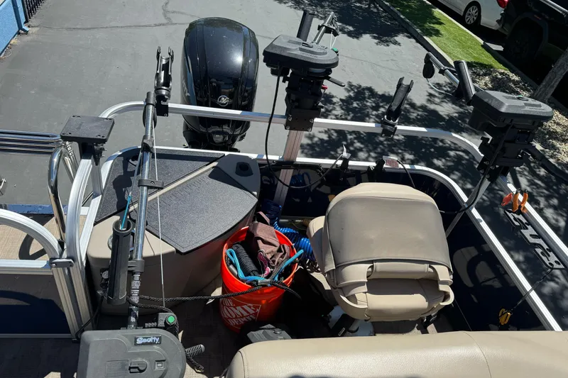Slide: The Image of 2025 Sun Tracker Bass Buggy 18 DLX interior with fishing gear and motor. - 30