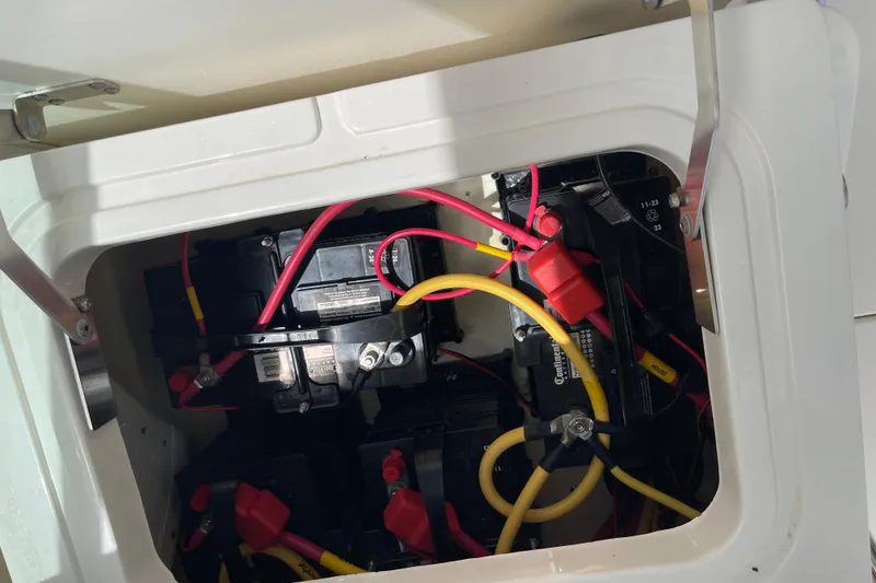 Slide: The Image of Battery compartment of 2023 Cobia 280 Dual Console with visible wiring and connections. - 21