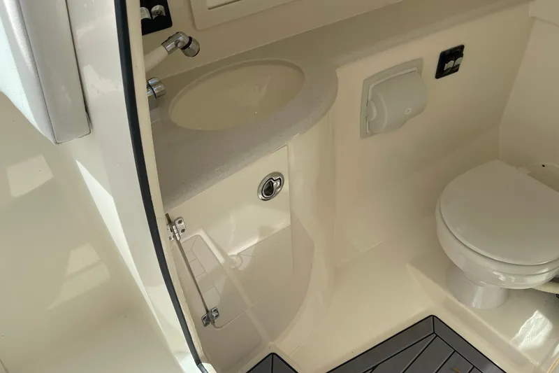 Slide: The Image of 2023 Cobia 280 Dual Console boat bathroom with sink and toilet. - 22
