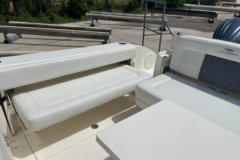 Slide: The Image of 2023 Cobia 280 Dual Console boat interior with white seating and sleek design. - 29