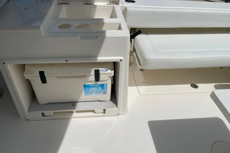 Slide: The Image of 2023 Cobia 280 Dual Console boat interior with Engel cooler and seating area. - 30