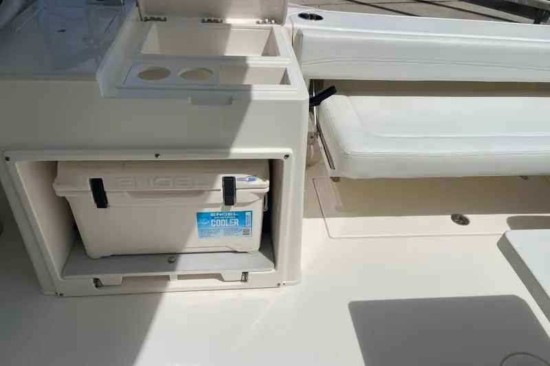 Slide: The Image of 2023 Cobia 280 Dual Console boat interior with Engel cooler and seating area. - 31