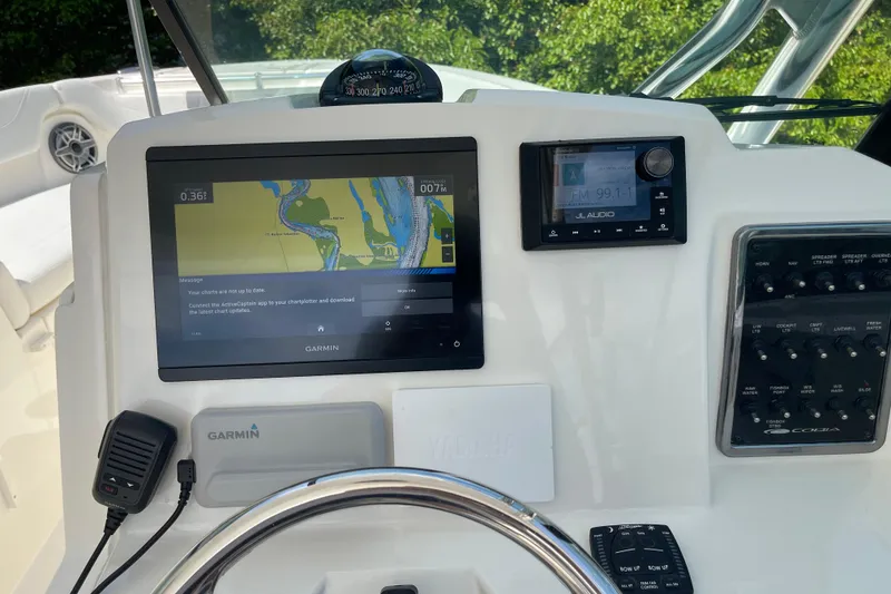 Slide: The Image of 2023 Cobia 280 Dual Console dashboard with Garmin navigation and JL Audio system. - 35