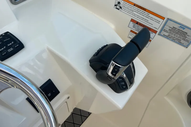Slide: The Image of Throttle control and steering wheel of 2023 Cobia 280 Dual Console boat. - 38