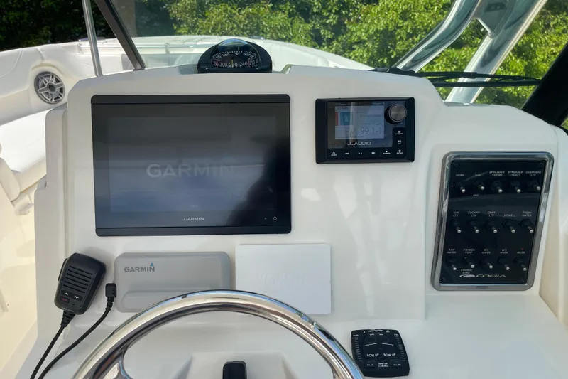 Slide: The Image of 2023 Cobia 280 Dual Console dashboard with Garmin display and JL Audio system. - 39