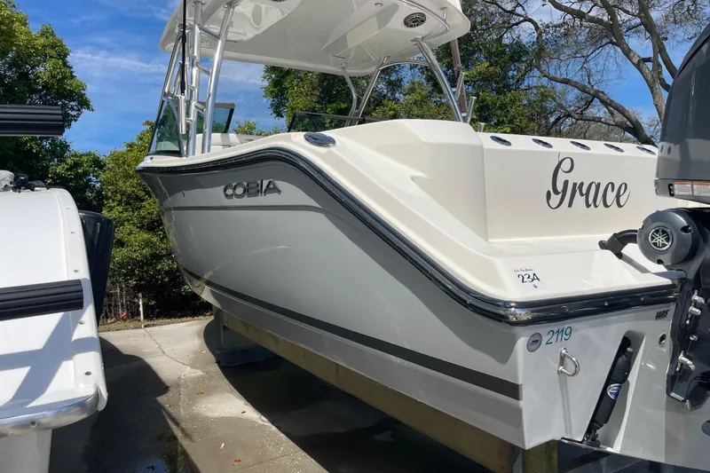 Slide: The Image of 2023 Cobia 280 Dual Console boat named "Grace" on display outdoors. - 42