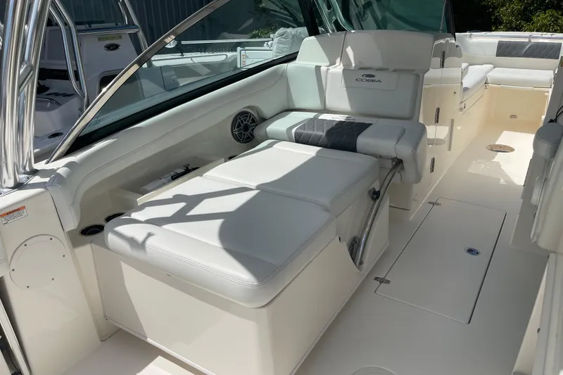 Slide: The Image of 2023 Cobia 280 Dual Console boat interior with white seating and sleek design. - 48