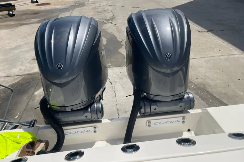 Slide: The Image of 2023 Cobia 280 Dual Console with twin outboard motors on display. - 49