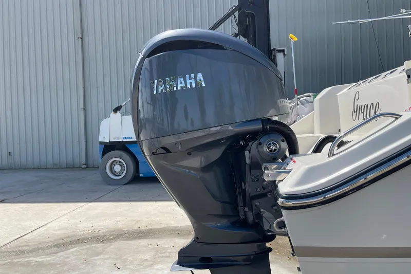 Slide: The Image of 2023 Cobia 280 Dual Console with Yamaha outboard motor in marina setting. - 50