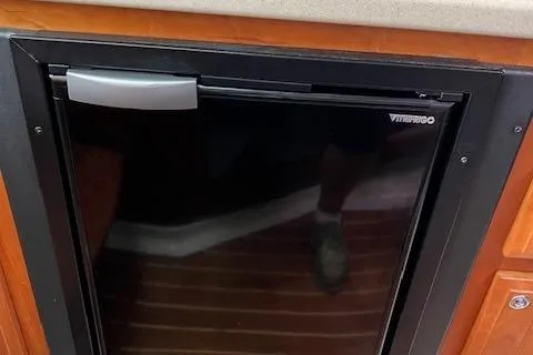 Slide: The Image of 2005 Back Cove Downeast Hardtop boat interior with a compact Vitrifrigo refrigerator. - 12