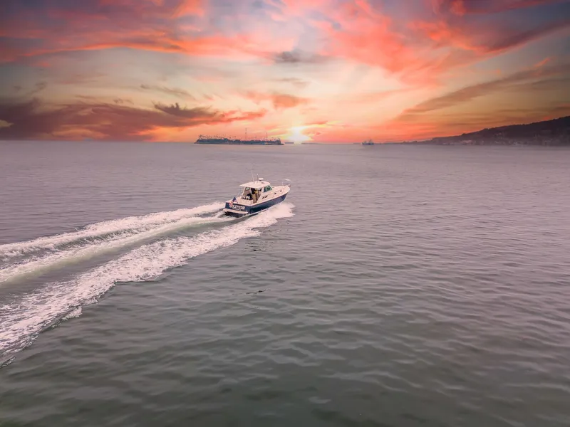 Slide: The Image of 2005 Back Cove Downeast Hardtop cruising at sunset on open water. - 49