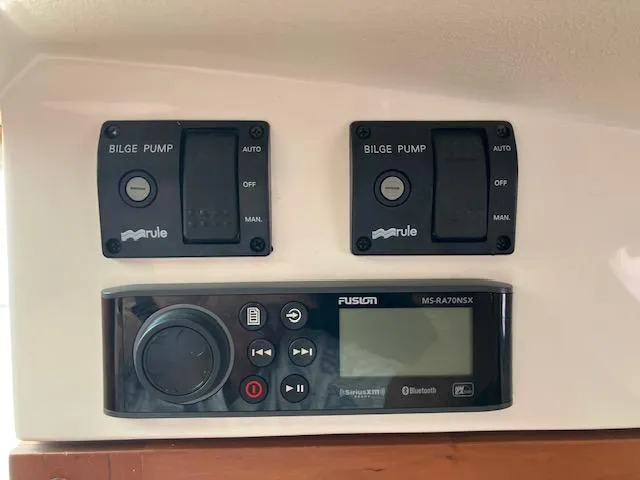 Slide: The Image of Control panel of a 2005 Back Cove Downeast Hardtop boat with bilge pump switches. - 9