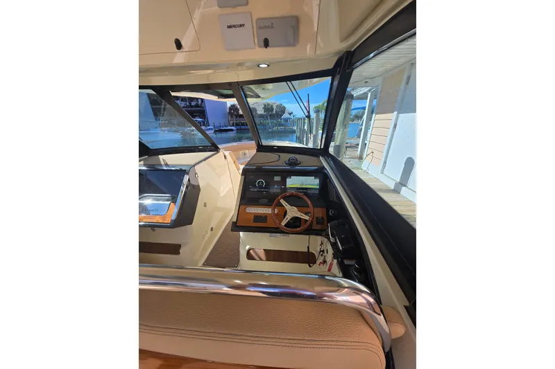 Slide: The Image of 2023 Chris-Craft Calypso 35 boat interior with steering wheel and dashboard controls. - 16