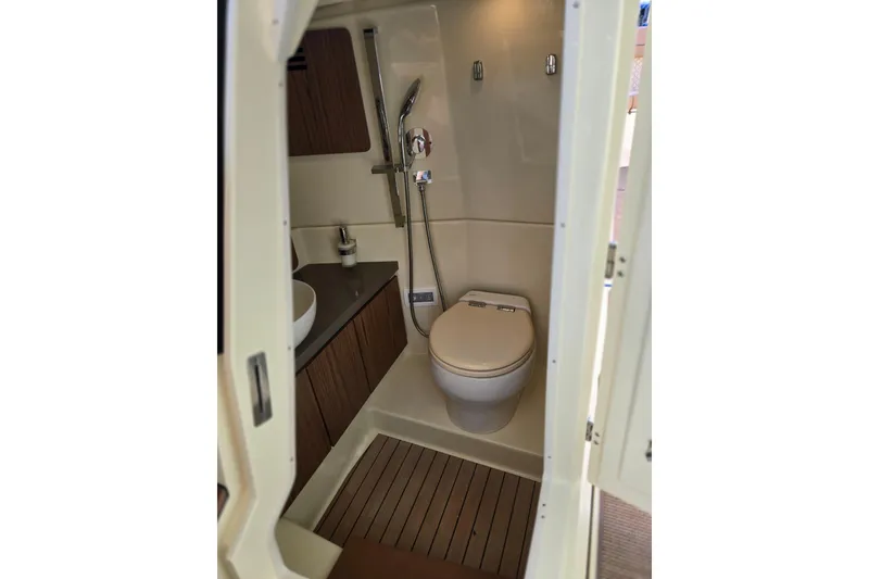 Slide: The Image of 2023 Chris-Craft Calypso 35 boat bathroom with modern fixtures and wooden accents. - 21