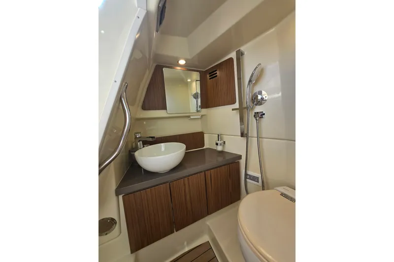 Slide: The Image of Luxurious bathroom in 2023 Chris-Craft Calypso 35 boat with modern fixtures and wood accents. - 22