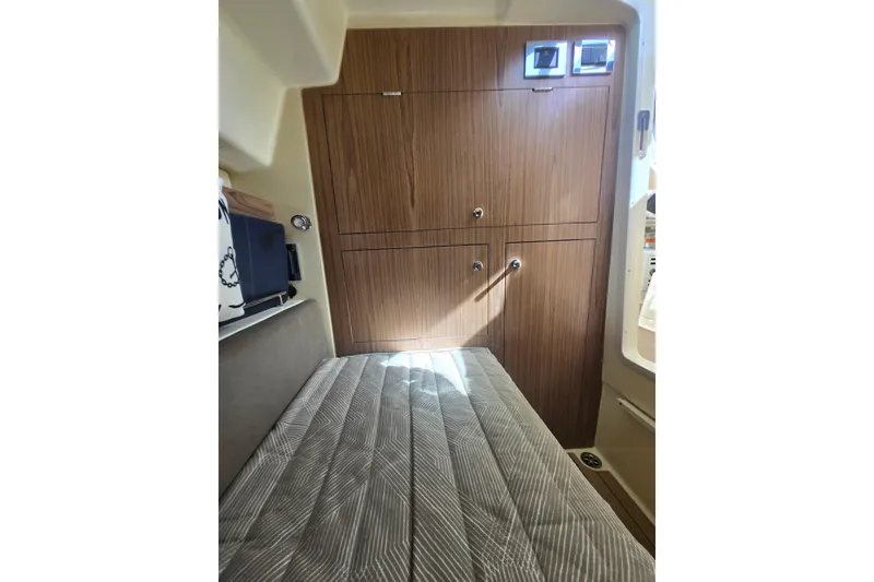 Slide: The Image of 2023 Chris-Craft Calypso 35 cabin interior with wood cabinetry and cushioned seating. - 25